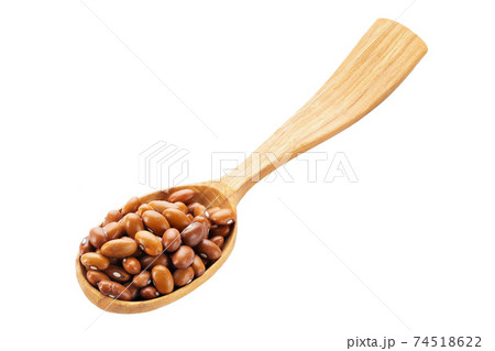 Dried orange beans in a wooden spoon isolated on a white background. Healthy food concept. Dried orange beans in a wooden spoon isolated on a white background. Healthy food concept. 74518622