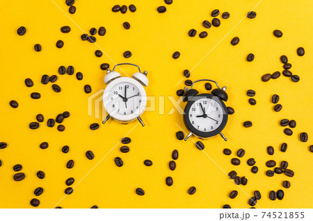 Alarm clock with coffee on yellow paper background. Work and planning time flat lay concept. 74521855