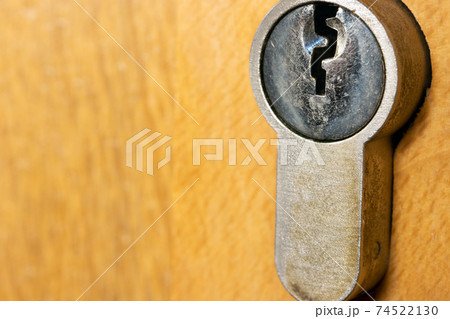 The keyhole in a wooden door lock, close up view. The keyhole in a wooden door lock, close up view. 74522130