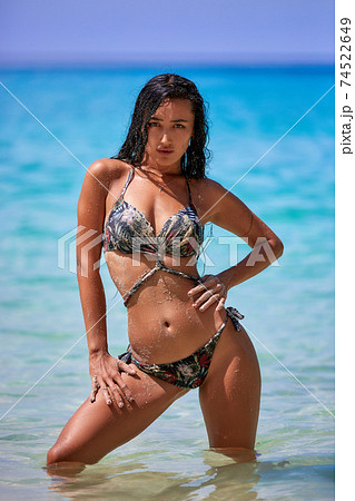 Sexy girl posing in the sunny day at the tropical beach Sexy girl posing in the sunny day at the tropical beach 74522649