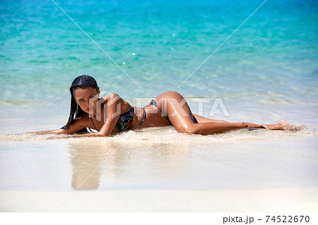 Sexy woman taking off top on beach - Stock Photo [79816064] - PIXTA