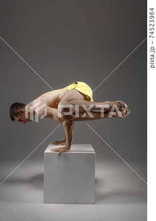 Yoga keeps balanc on hands in difficult pose 74523964