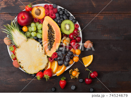 Fresh raw organic summer berries and exotic fruits 74524679