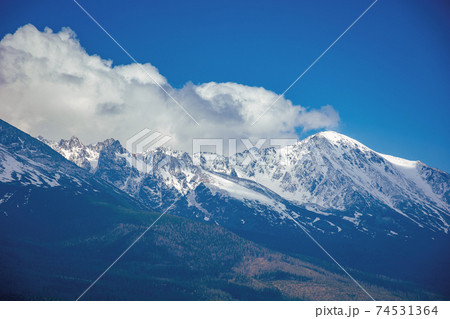 high tatra mountain ridge in springtime. cloud above the snow capped rocky peaks. beautiful sunny weather. wonderful nature scenery high tatra mountain ridge in springtime. cloud above the snow capped rocky peaks. beautiful sunny weather. wonderful nature scenery 74531364