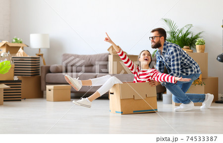 Cheerful couple having fun in new apartment 74533387