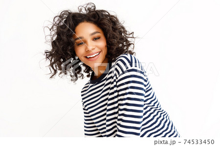 Happy ethnic woman with curly hair Happy ethnic woman with curly hair 74533450