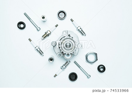 Car motor parts. Auto motor mechanic spare or automotive piece on white background. Set of new metal car part. Flat lay, top view, copy space. Car motor parts. Auto motor mechanic spare or automotive piece on white background. Set of new metal car part. Flat lay, top view, copy space. 74533966