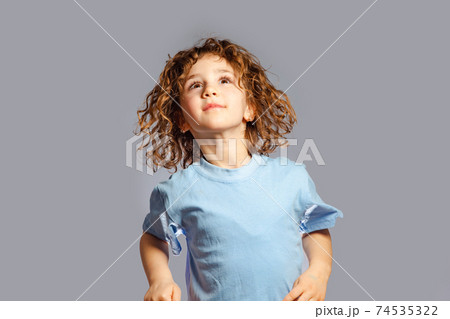 little girl jumps on a gray background 74535322