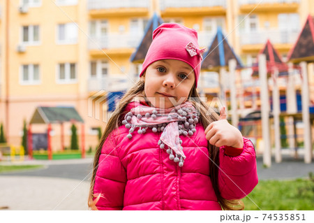 Girl portrait with thumb up at outdoor playground 74535851