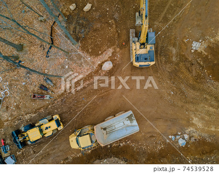 Aerial view machinery and heavy-duty equipments at large construction site of excavator, bulldozer, dump truck, digger 74539528