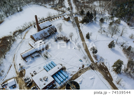 Aerial view of modern little industrial sewage treatment plant at work in winter season Aerial view of modern little industrial sewage treatment plant at work in winter season 74539544