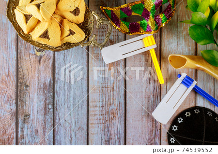 Hamans ears cookies noisemaker and mask for Purim celebration jewish carnival holiday 74539552