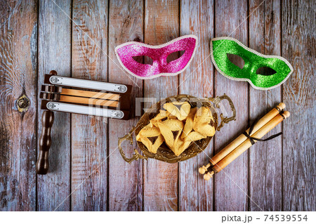 Hamans ears cookies noisemaker and mask for Purim celebration jewish carnival holiday 74539554