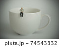 Elderly businessman sitting and drinking coffee 74543332