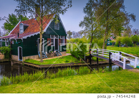 Dutch wooden house and bridge in Zaanse Schans village, Netherlands Dutch wooden house and bridge in Zaanse Schans village, Netherlands 74544248