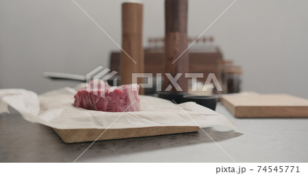 man salting new york steak on countertop 74545771