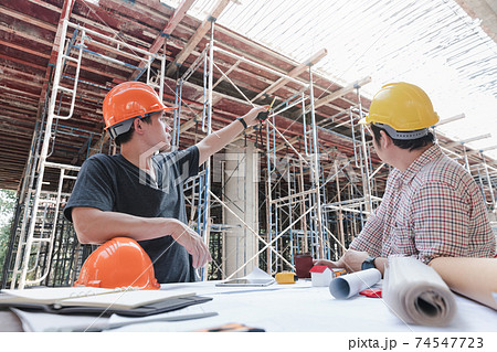 Construction concept of Engineer and Architect working at Construction Site with blue print Construction concept of Engineer and Architect working at Construction Site with blue print 74547723