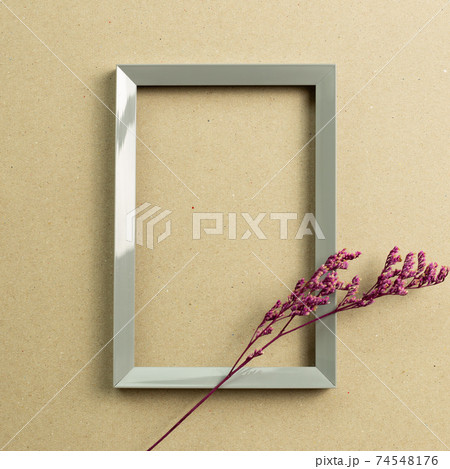 Empty photo frame with pink misty blue dry flowers on brown kraft paper background. top view, copy space Empty photo frame with pink misty blue dry flowers on brown kraft paper background. top view, copy space 74548176