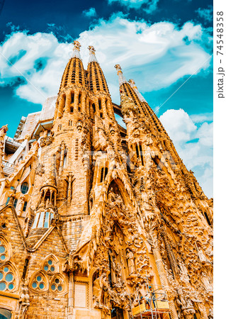 BARCELONA, SPAIN - SEPT 02, 2014: The Basilica of La Sagrada Familia against blue sky.Most amazing and fabulous creations of the great architect by Antoni Gaudi, its construction began in 1882 and BARCELONA, SPAIN - SEPT 02, 2014: The Basilica of La Sagrada Familia against blue sky.Most amazing and fabulous creations of the great architect by Antoni Gaudi, its construction began in 1882 and 74548358