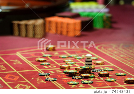 close-up of casino chips on the red table 74548432