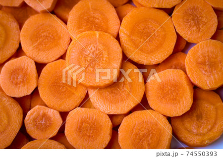 Delicious food background. Raw carrots cut into mugs 74550393