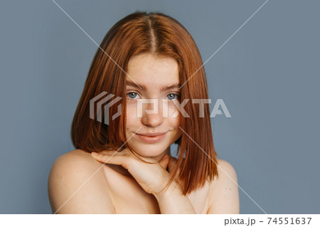 Woman looking at the camera with coquettish smile 74551637