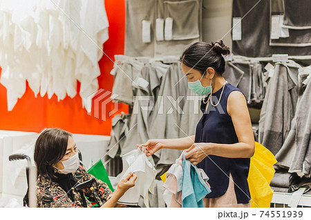 Elderly woman in wheelchair with daughter doing shopping in shopping store. Elderly woman in wheelchair with daughter doing shopping in shopping store. 74551939