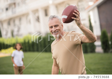 Father and a son playing a ball together and feeling excited Father and a son playing a ball together and feeling excited 74553688
