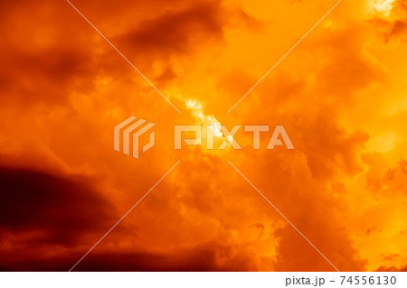 Fantastic concept mystical horror background from another planet from the paranormal world, fantasy style. Dramatic red black orange sky with scary hellish clouds and terrible shadows and light 74556130