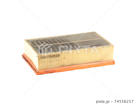 Dirty car air filter on a white background, isolate. The concept of replacing the filter element according to the car maintenance regulations, close-up Dirty car air filter on a white background, isolate. The concept of replacing the filter element according to the car maintenance regulations, close-up 74556257