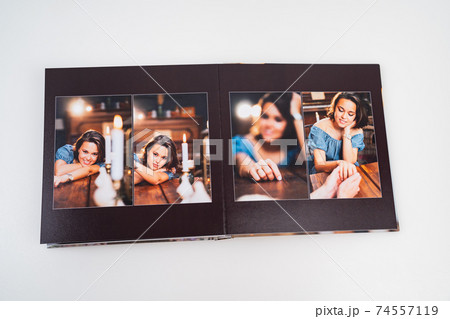 pages of photobook from photo shoots of beautiful brunette woman in retro house. 74557119