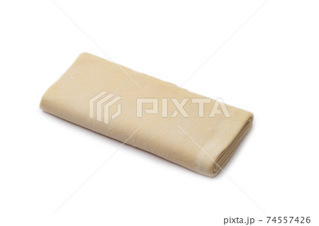 puff frozen dough for baking on a white background, isolate. Close-up, refreshment 74557426