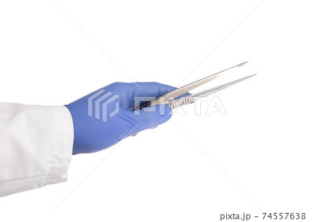 Doctor's hand in a medical glove holds a medical instrument tweezers for an operation on a white background, isolate. Doctor's hand in a medical glove holds a medical instrument tweezers for an operation on a white background, isolate. 74557638