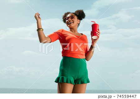 Portrait of female fashion model on blue sky background. Style and beauty concept, bright appearance 74559447