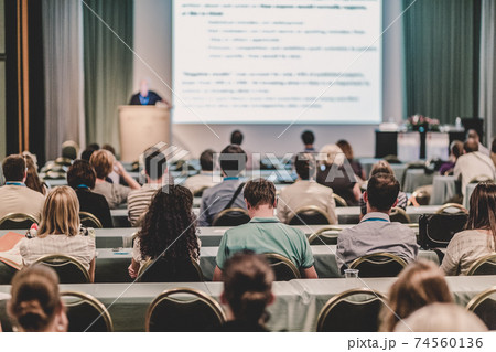 Audience in lecture hall participating at business conference. Audience in lecture hall participating at business conference. 74560136