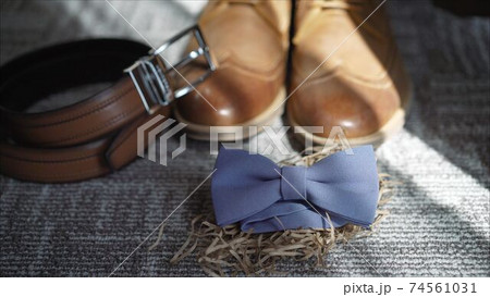 Fees the groom. The morning of the groom. Boots, butterfly, belt Wedding details. Male casual outfits. Top view, flat lay 74561031