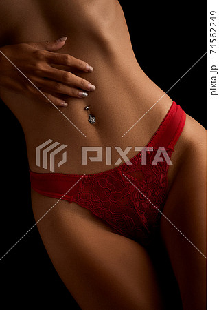 Foto de Art nude. Naked body, sexy girl red panties on black