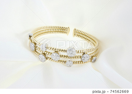Yellow Gold Bracelet With Diamonds On Soft White Background Yellow Gold Bracelet With Diamonds On Soft White Background 74562669