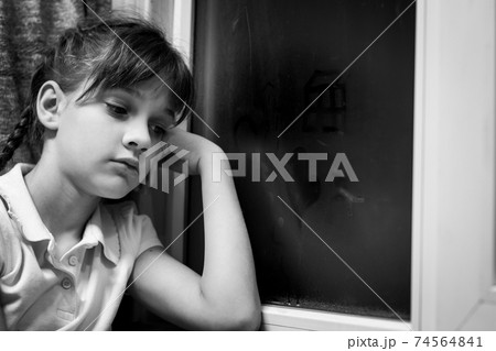 Girl draws figures of little men on a fogged window Girl draws figures of little men on a fogged window 74564841