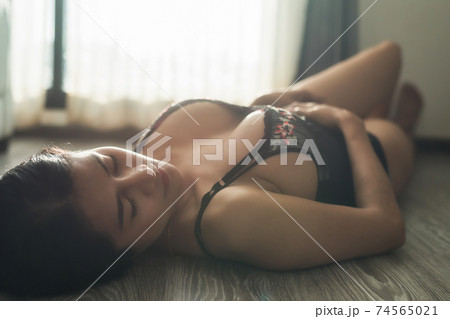 Asian sexy woman sleep by window with light flare Asian sexy woman sleep by window with light flare 74565021