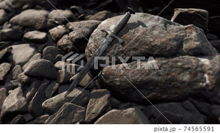 old dagger on the rock at sunset 74565591