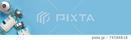 Coronavirus covid-19 experimental vaccine vials on a blue plate with copyspace in a laboratory 74566616