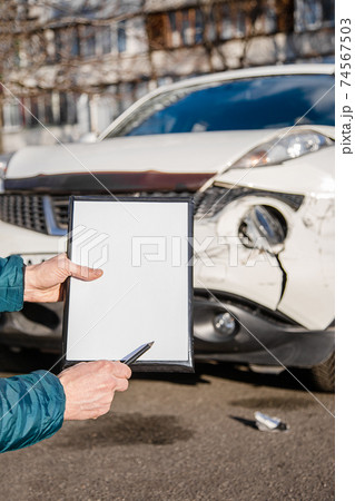 Space for text, blank document close up. An insurance agent will inspect and inspect vehicle damage after an accident. 74567503