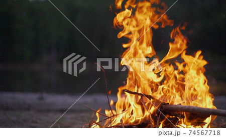 Bonfire on the beach sand. Bonfire by the lake. Bonfire on the beach sand. Bonfire by the lake. 74567718