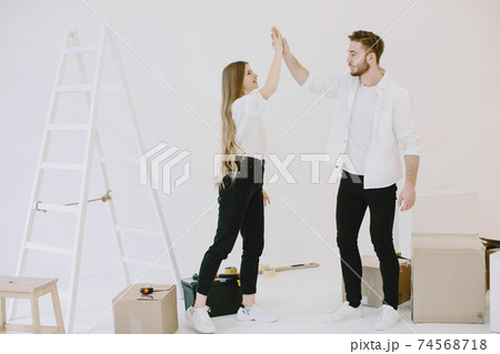 Couple moving and using a boxes Couple moving and using a boxes 74568718