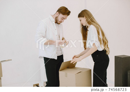 Couple moving and using a boxes 74568723