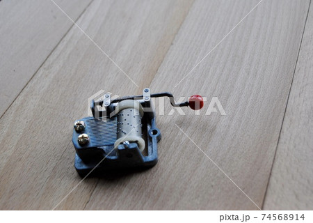 Vintage mechanical music box on wooden plank. Put music box on wooden surface to obtain maximum sound effect. Vintage mechanical music box on wooden plank. Put music box on wooden surface to obtain maximum sound effect. 74568914
