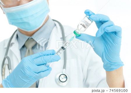 Coronavirus COVID-19 vaccine. Doctor holding Corona virus vaccine and syringe using for prevent COVID-19 infection. Medicine and Healthcare Coronavirus COVID-19 vaccine. Doctor holding Corona virus vaccine and syringe using for prevent COVID-19 infection. Medicine and Healthcare 74569100