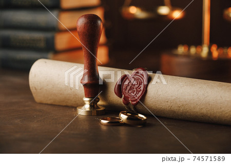 Notary public tools. Old stamp and document on a table Notary public tools. Old stamp and document on a table 74571589