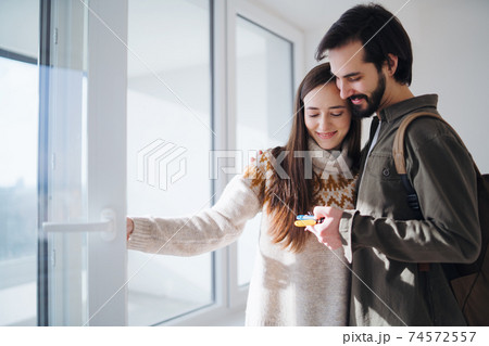 Young couple with keys moving in new flat, new home and relocation concept. 74572557